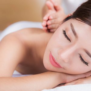 The girl relaxes in the spa salon with hand massage